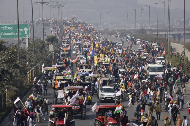 Hundreds of people and cars can be seen on a highway during the protest